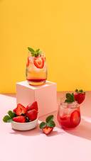 Mojito Cocktail with Strawberries on Yellow Background