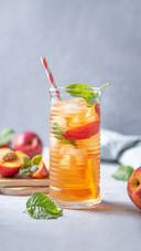 Cool Peach Tea with Mint and Ice in a Glass