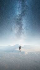 Man Standing Alone in The Snow Under The Stars