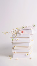 Stack of Books with Spring Flowers between Pages