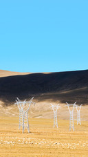 High-voltage lines and electricity pylon on the hillside