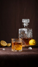 glasses of rum with ice and lemon on the brown background