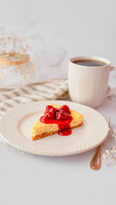 Slice of cheesecake covered with a cherry glaze