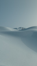 Snow falls into the sea of sand