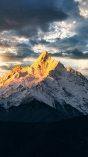 The menzmu peak is bathed in sunlight like a golden