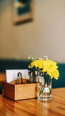 Still life flowers in a vase on a table in a coffee shop