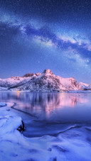 Snow Mountain And Lake Under The Stars