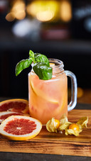A Glass of Juice And Oranges
