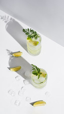 Two Glasses of Detox Drink with Fruit and Ice