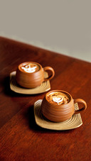 Two Brown Cups of Hot Cappuccino on Wooden Table