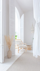 A Bright Apartment with White Walls and Bamboo Furniture