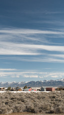Winter pastures surrounded by mountain ranges