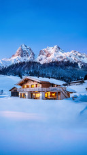 Wooden Chalet in The Alps On A Cold Winter Evening