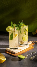 A Glass of Mojito with Mint Leaf, Ice, Lemon and Sugar