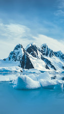 Blue Ice Covered Mountains in South Polar Ocean