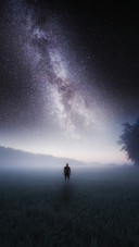 Man Standing Alone on The Grass Under The Stars
