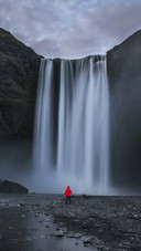 Man Standing Under The Waterfall