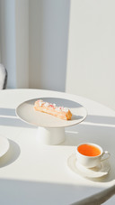 Tea time - dessert eclair on white table