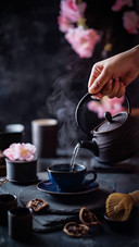A Man Pours Hot Water into A Tea Cup