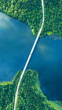 Aerial view of bridge, road, cars and blue water