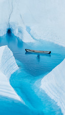 A Small Boat Parked on The Water in The Glacier