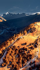 The snowcapped mountains and autumn forests in western