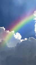 Rainbow in Cloudy Sky
