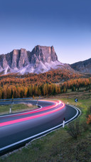 Winding Asphalt Road in Mountains at Sunset in Autumn