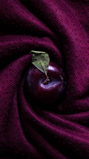 Purple fabric and plums