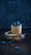 Blueberries in wicker box on a wooden table