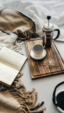 Open Book in Bed with Coffee Brewed