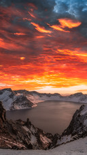 In winter the snowcapped mountains are ablaze with clouds