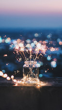 Sparklers in A Glass Jar That Bokeh Cities Background