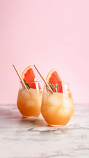 Glasses of grapefruit cocktails on table