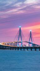 Curved Suspension Bridge, Lit Up in Blue at Dusk