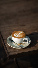 Coffee on the corner of a wooden table