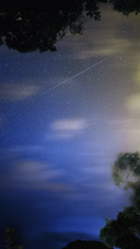The trajectory of a meteor streaking across the night sky