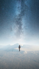 Man Standing Alone in The Snow Under The Stars