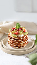 Pancakes with fruits and berries on the white background