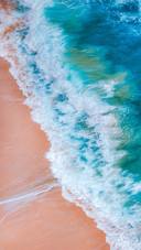 The Colorful Waves On The Sandy Beach