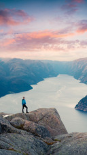 Man Standing on The Cliff Looking at The River Below