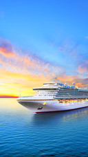 Luxury cruise ship sailing to port on sunrise