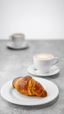 Cappuccino and croissant on a table