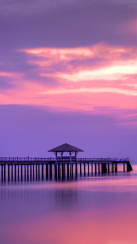 Wooded bridge in the port between sunrise
