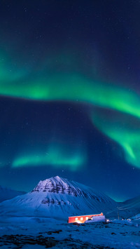 The polar Northern lights in the mountains house of Svalbard