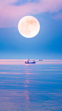 local fishing boat in the quiet sea on the full moon night