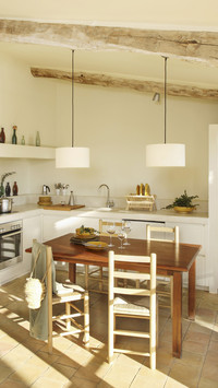 Dining area in rustic kitchen without wall units