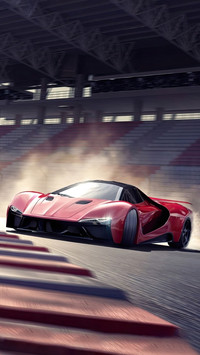 The red sports car was drifting down the track