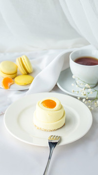 Minimalistic cake with cup of tea on the table side view