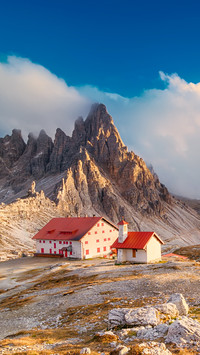 Autumn Dolomites sunset with blue cloudy sky